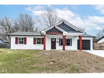 Newly constructed home featuring a charming front porch and attached garage at 3931 Marietta Ct, Indianapolis, IN 46235