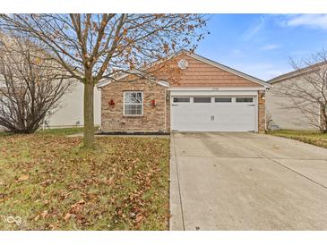 Brick ranch home with attached garage and landscaped yard at 1705 Blue Grass Pkwy, Greenwood, IN 46143