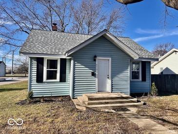 Charming light blue house with a gray roof, landscaping, and walkway at 2019 S Shipley St, Muncie, IN 47302