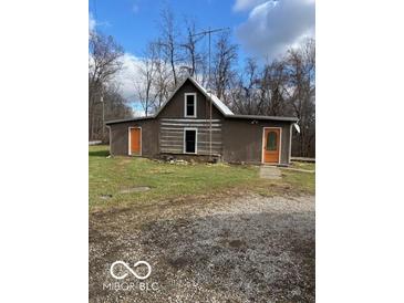 Rustic log cabin home with a metal roof and orange doors at 5967 S Lick Creek Rd, Morgantown, IN 46160
