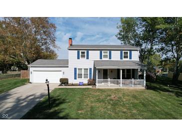 Two-story house with gray siding, blue shutters, and a covered porch at 6031 S Eaton Ave, Indianapolis, IN 46259