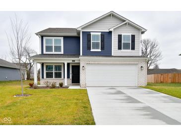 Two-story home with navy blue and beige siding, white garage door, and landscaped lawn at 6329 Basden Dr, Indianapolis, IN 46221