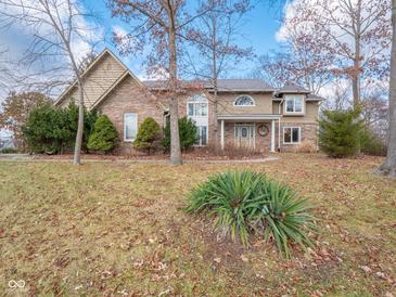 Brick two-story house with a large front yard and mature trees at 8530 Bluefin Cir, Indianapolis, IN 46236