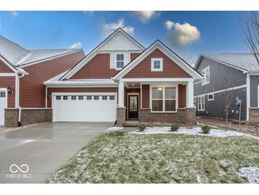 Brick and shingle two-story home with a covered porch and two-car garage at 3923 Holly Brook Dr, Westfield, IN 46062