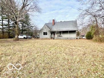 Ranch home with front porch and large yard at 5700 W State Road 46, Columbus, IN 47201