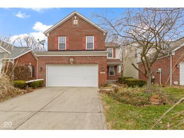 Brick two-story home with attached garage and landscaping at 8022 Buford St, Indianapolis, IN 46216