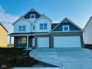 Two-story home with gray and white exterior, two-car garage, and a large driveway at 821 Blaine Dr, Whiteland, IN 46184