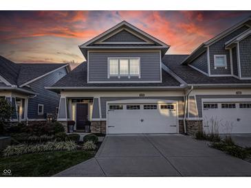 Gray two-story townhome with white garage door and landscaping at 470 Chimney Rock Dr, Carmel, IN 46032