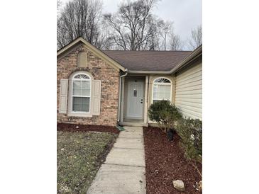 Brick ranch home with walkway, landscaping, and a white front door at 2914 Rothe Ln, Indianapolis, IN 46229