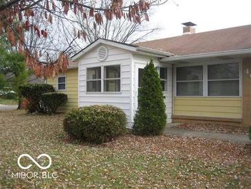 Ranch home with attached sunroom and landscaped yard at 4071 Sawyer St, Indianapolis, IN 46226