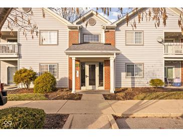 Attractive exterior of a condo building with brick accents and landscaping at 8224 Glenwillow Ln # 206, Indianapolis, IN 46278