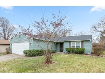 Charming ranch home with attached garage and landscaped lawn at 3713 Oil Creek Dr, Indianapolis, IN 46268