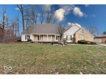 Eye-catching ranch home with stone accents and a spacious lawn at 910 Sleepy Hollow Pl, Greenwood, IN 46142