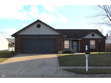 Brick ranch home with gray trim, attached garage, and landscaping at 6631 Furnas Rd, Indianapolis, IN 46221