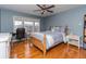 Bright bedroom with hardwood floors, a double bed, and a built-in desk at 2569 Dawn Ridge Dr, Carmel, IN 46074