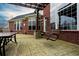 Brick patio with pergola, seating, and swing bench at 2569 Dawn Ridge Dr, Carmel, IN 46074