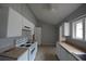 Eat-in kitchen with white cabinets and a four-burner stove at 1921 E 116 St, Carmel, IN 46032