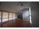 Spacious living room with hardwood floors, large windows, and a ceiling fan at 1921 E 116 St, Carmel, IN 46032