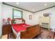 Bedroom with antique wooden bed, red bedding, and a chest of drawers at 19431 Prairie Baptist Rd, Noblesville, IN 46060