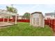 Landscaped backyard with shed and playground set at 5321 Basin Park Dr, Indianapolis, IN 46239