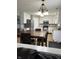 Kitchen with white cabinets, tile floors, and a dining table at 9115 Cornus Ct, Indianapolis, IN 46113