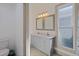 Bathroom boasts double vanity with gray cabinets and elegant mirrors at 412 W 11Th St, Anderson, IN 46016