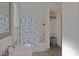 Bright bathroom with shower/tub combo and a seashell-themed curtain at 412 W 11Th St, Anderson, IN 46016