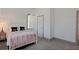 Cozy bedroom with white metal bed frame and soft pink bedding at 412 W 11Th St, Anderson, IN 46016