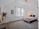 Charming bedroom with a white metal bed frame and pink bedding at 412 W 11Th St, Anderson, IN 46016