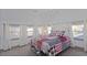 Spacious bedroom with a metal bed frame and red/black bedding at 412 W 11Th St, Anderson, IN 46016