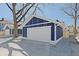 One-car garage with white door and blue siding at 412 W 11Th St, Anderson, IN 46016