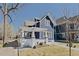 Charming two-story blue home with white trim and a pergola-covered porch at 412 W 11Th St, Anderson, IN 46016