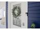 White front door with glass panels, a wreath, and a keyless entry at 412 W 11Th St, Anderson, IN 46016
