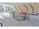 Relaxing front porch with red metal bench and gray chairs at 412 W 11Th St, Anderson, IN 46016