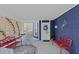 Inviting front porch with red benches, a floral rug, and a wooden privacy screen at 412 W 11Th St, Anderson, IN 46016