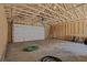 Unfinished garage with a large garage door and concrete floor at 412 W 11Th St, Anderson, IN 46016