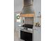 Modern kitchen with stainless steel range and custom-built vent hood at 412 W 11Th St, Anderson, IN 46016