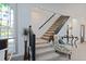 View of a carpeted staircase with dark wood railings at 412 W 11Th St, Anderson, IN 46016
