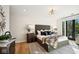 Spacious bedroom with plush bedding and access to a balcony at 41 N Rangeline Rd # 2, Carmel, IN 46032