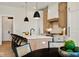 Open concept kitchen with island seating and modern pendant lighting at 41 N Rangeline Rd # 2, Carmel, IN 46032