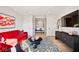 Sophisticated living room featuring a red sofa, coffee table, and large TV at 41 N Rangeline Rd # 2, Carmel, IN 46032