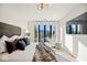 Bright bedroom features a king-size bed and city views at 41 N Rangeline Rd # 2, Carmel, IN 46032
