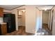 Modern kitchen with dark wood cabinets, black appliances, and granite countertops at 31 Blue Water Dr, Cicero, IN 46034
