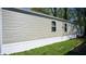 Tan-colored mobile home exterior with white trim and landscaping at 31 Blue Water Dr, Cicero, IN 46034