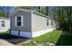 Single-wide manufactured home with light gray siding and white trim at 31 Blue Water Dr, Cicero, IN 46034