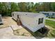 Beige mobile home with dark brown roof and wooden steps at 29 Blue Water Dr, Cicero, IN 46034