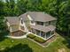 Two-story house with a wraparound porch, situated on a wooded lot at 1104 W Greencastle Road, Mooresville, IN 46158