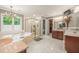 Large bathroom with double sinks, a soaking tub, and a walk-in shower at 1104 W Greencastle Road, Mooresville, IN 46158