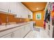 Laundry room with white cabinets and an orange accent wall at 1104 W Greencastle Road, Mooresville, IN 46158
