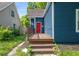 Front porch with red door and wooden steps at 945 Eugene St, Indianapolis, IN 46208